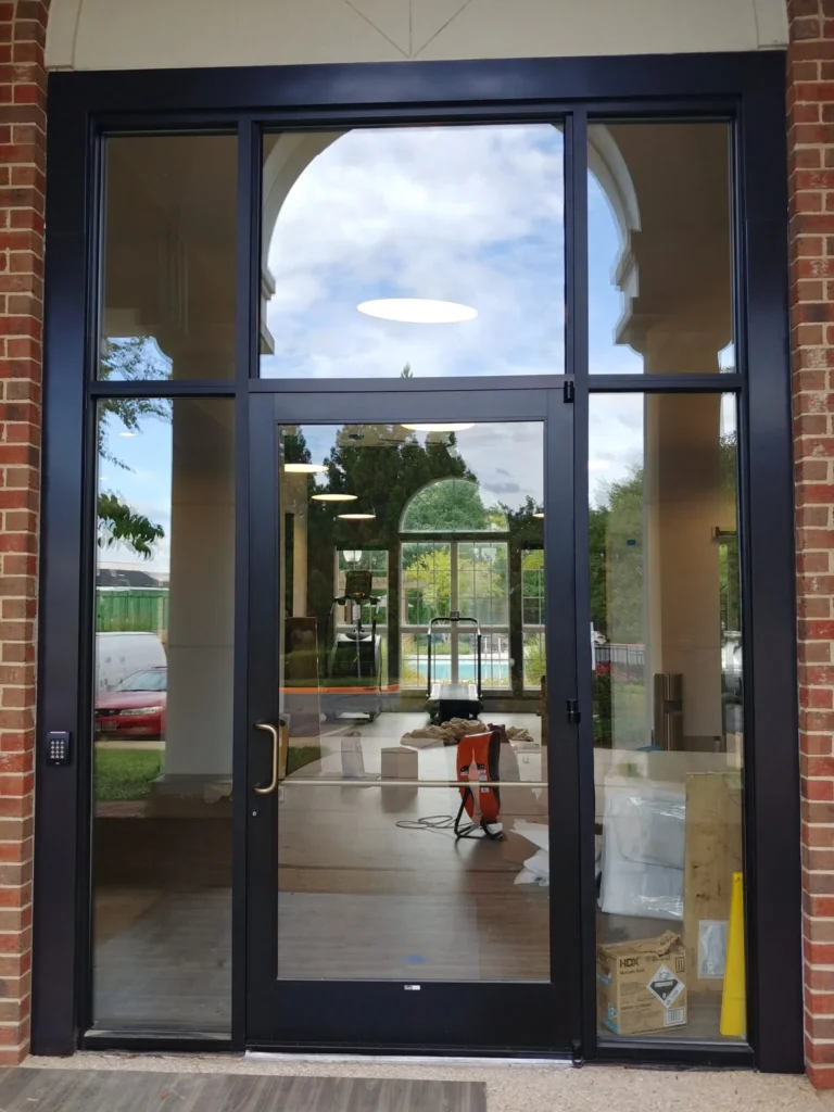 Commercial glass entrance doors in a brick storefront